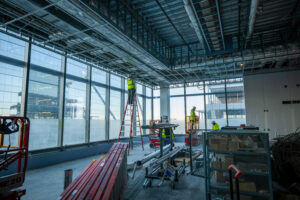 Inside the CoStar building while under construction showing workers installing ductwork