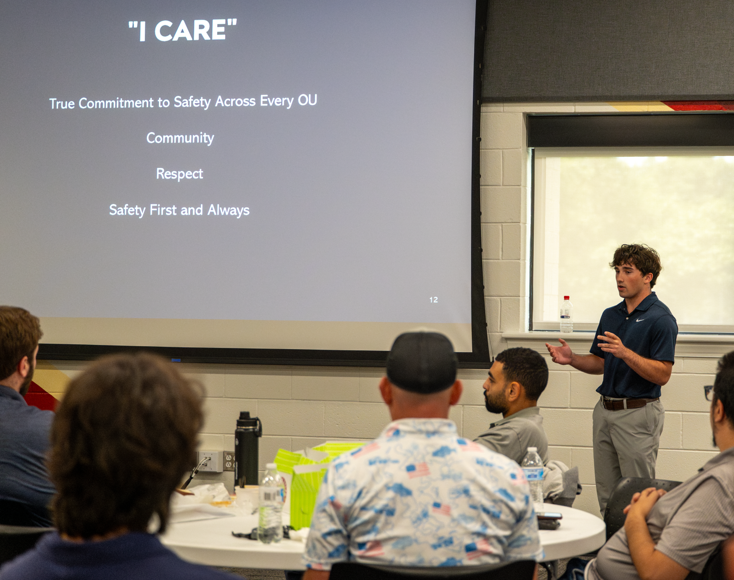 An intern gives a presentation to coworkers